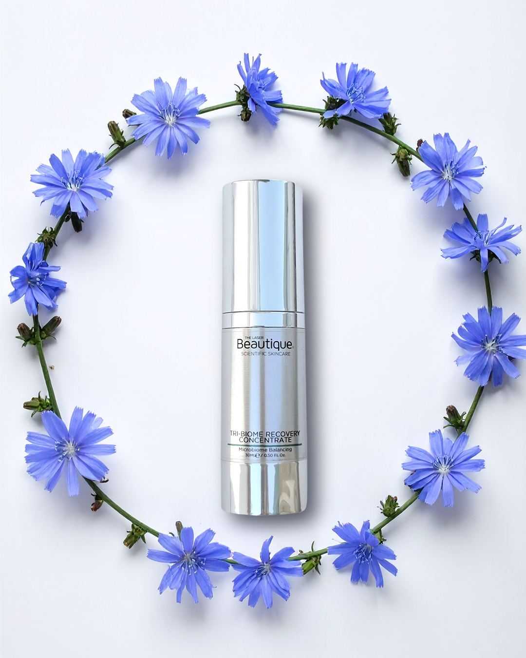 Tri-Biome Recovery Concentrate Serum product with purple flowers surrounding the product in a circle